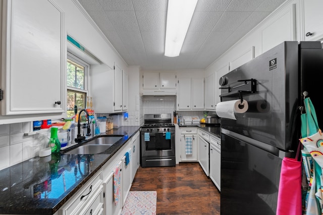 kitchen with white cabinets, black refrigerator, gas range, and sink