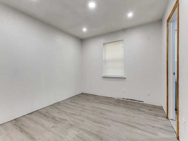 spare room with light wood-type flooring