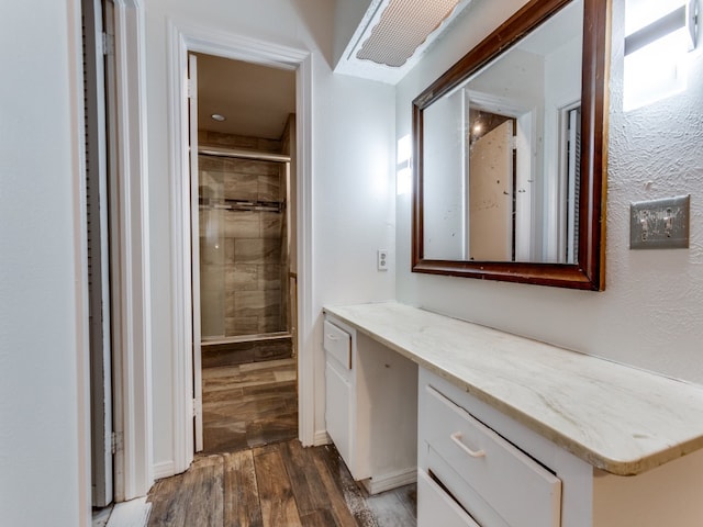 bathroom featuring an enclosed shower, hardwood / wood-style flooring, and vanity