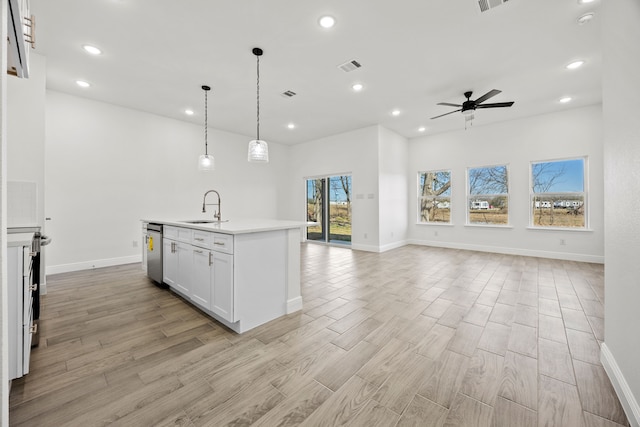 kitchen featuring visible vents, light wood-type flooring, open floor plan, and a sink