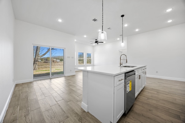 kitchen with visible vents, a sink, open floor plan, wood finished floors, and stainless steel dishwasher