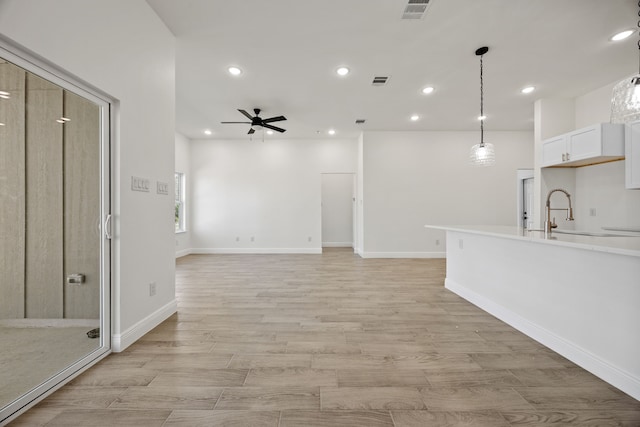 unfurnished living room featuring visible vents, recessed lighting, and a ceiling fan