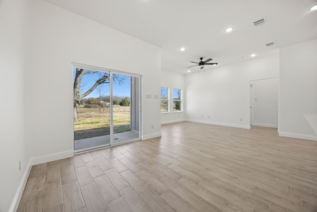 unfurnished living room featuring recessed lighting, light wood-type flooring, baseboards, and a ceiling fan