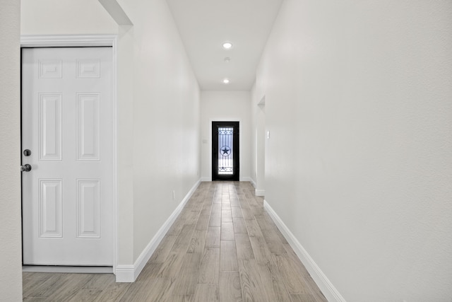 doorway to outside featuring recessed lighting, baseboards, and light wood-style floors