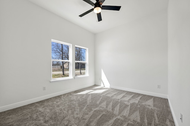 empty room with carpet flooring, a ceiling fan, and baseboards