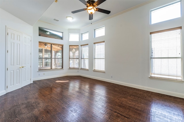 spare room featuring ornamental molding, ceiling fan, and dark hardwood / wood-style flooring