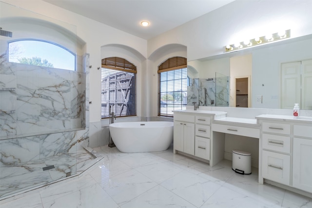 bathroom featuring shower with separate bathtub, a wealth of natural light, and vanity