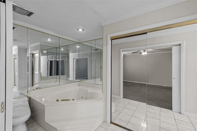 bathroom with a tub to relax in, a textured ceiling, ceiling fan, ornamental molding, and toilet