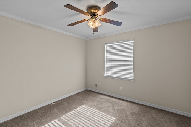 spare room with ornamental molding, ceiling fan, and light colored carpet