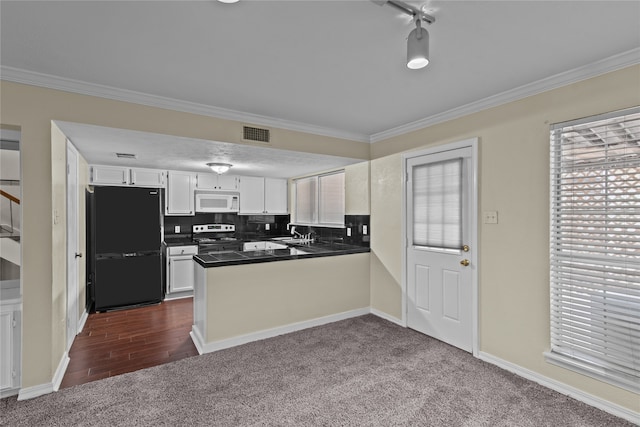 kitchen with black refrigerator, dark colored carpet, stainless steel electric range, and white cabinets