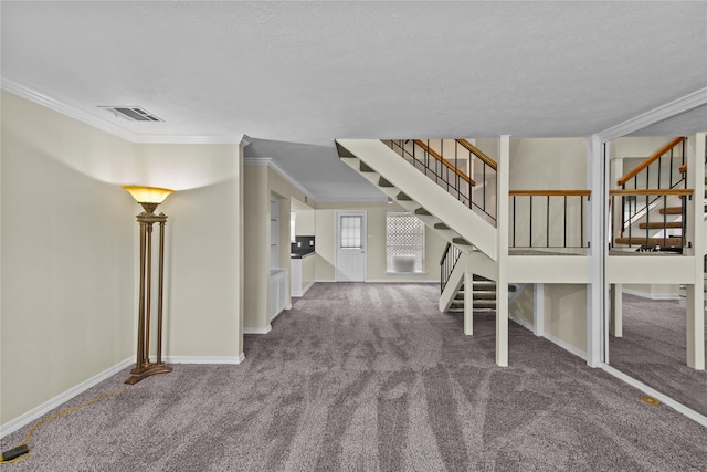 interior space with a textured ceiling, crown molding, and carpet