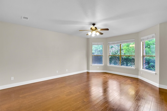 empty room featuring wood-type flooring and ceiling fan