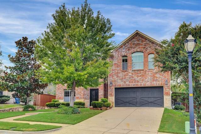 view of property with a garage and a front yard