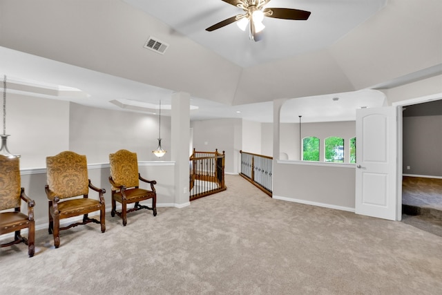 sitting room featuring light carpet, vaulted ceiling, and ceiling fan