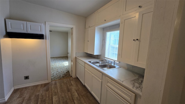 kitchen with white cabinets, dark hardwood / wood-style floors, and sink