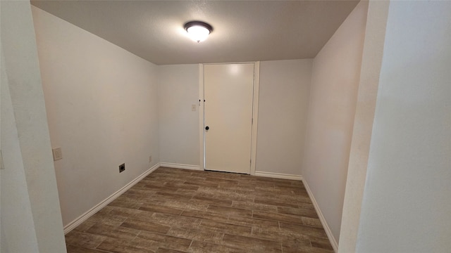 unfurnished room with dark wood-type flooring