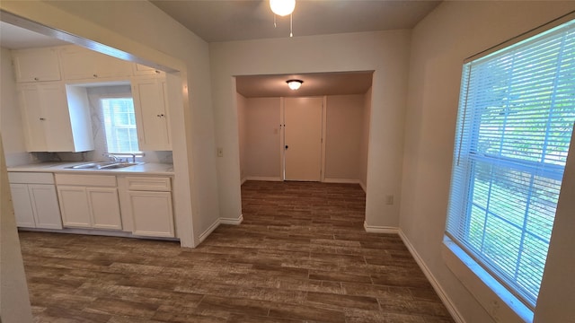 corridor featuring dark wood-type flooring and sink