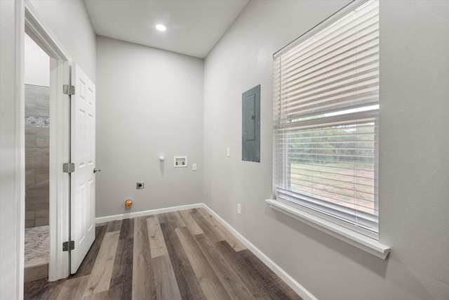 washroom featuring wood-type flooring, washer hookup, electric panel, and hookup for an electric dryer