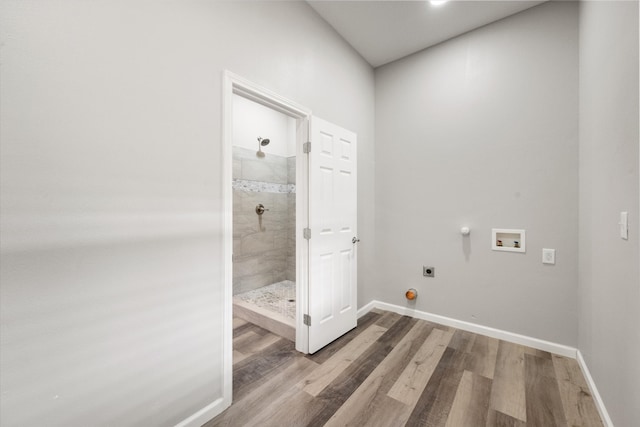 washroom featuring wood-type flooring, washer hookup, gas dryer hookup, and hookup for an electric dryer