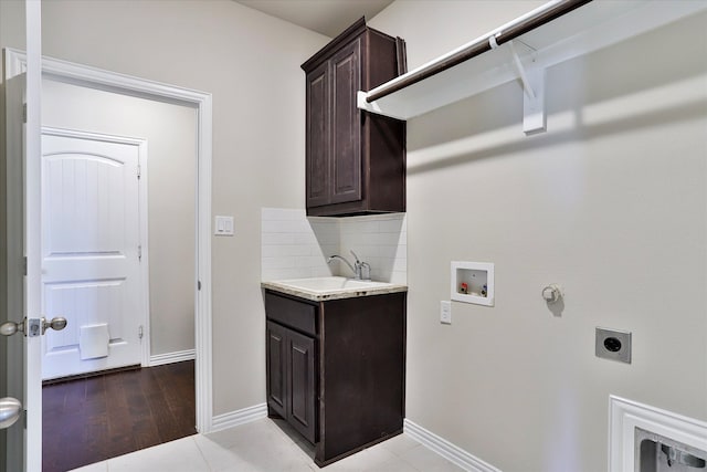 laundry area with washer hookup, light hardwood / wood-style flooring, hookup for an electric dryer, sink, and cabinets