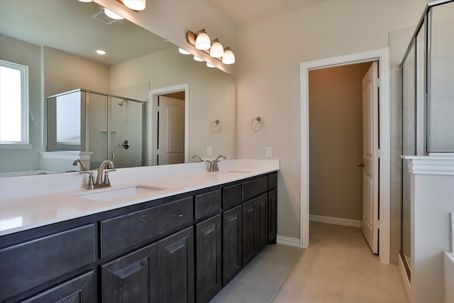 bathroom with vanity, tile patterned floors, and a shower with door