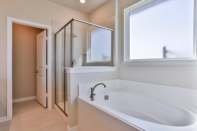 bathroom with tile patterned floors and shower with separate bathtub