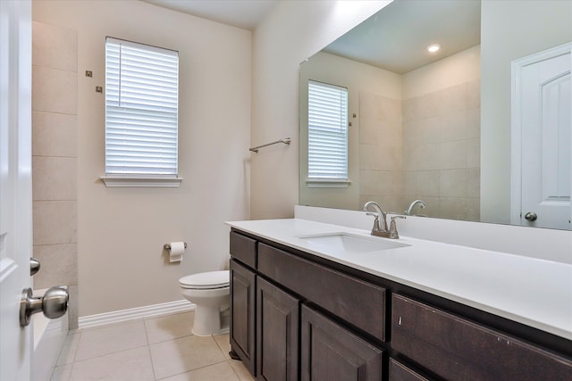 bathroom featuring vanity, toilet, tile patterned floors, and a wealth of natural light