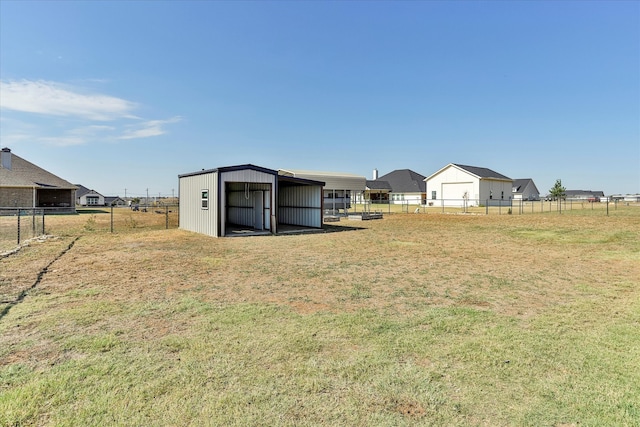 view of yard featuring a garage and an outdoor structure