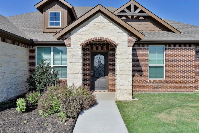 property entrance with a lawn