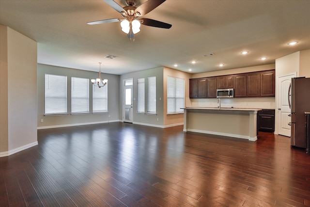 kitchen with a kitchen island with sink, dark hardwood / wood-style floors, and stainless steel appliances