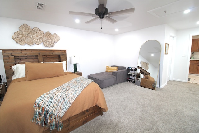 carpeted bedroom featuring ceiling fan and ensuite bathroom