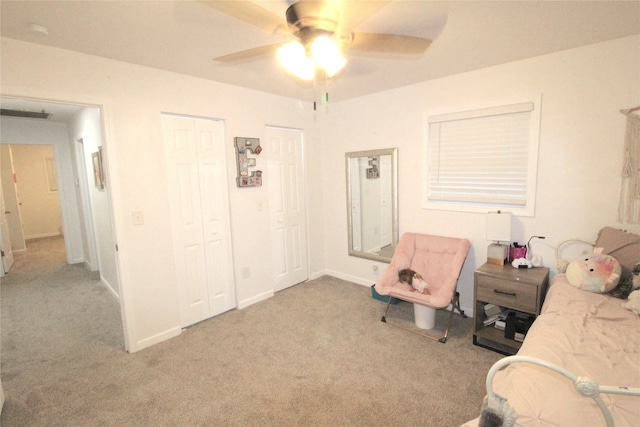 living area featuring ceiling fan and light carpet