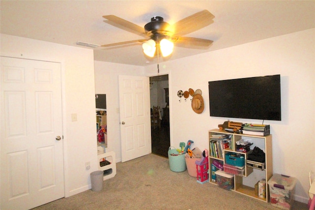 recreation room featuring carpet and ceiling fan