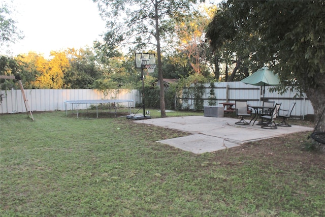 view of yard featuring a trampoline and a patio area