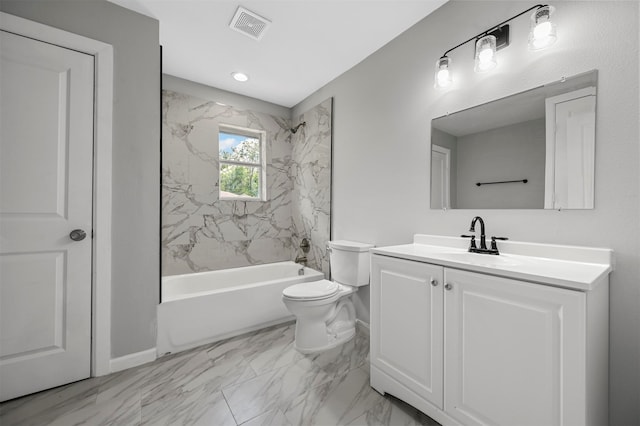 full bathroom with toilet, vanity, and tiled shower / bath