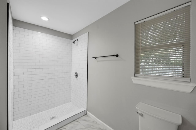 bathroom featuring toilet and tiled shower