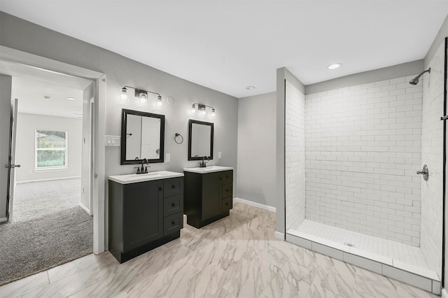 bathroom featuring a tile shower and vanity