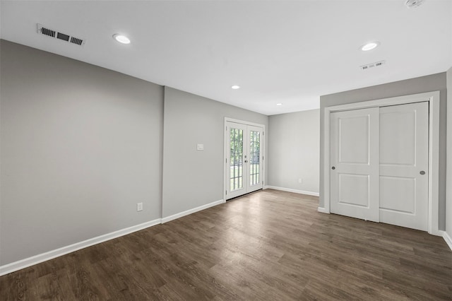 unfurnished room featuring dark hardwood / wood-style floors and french doors