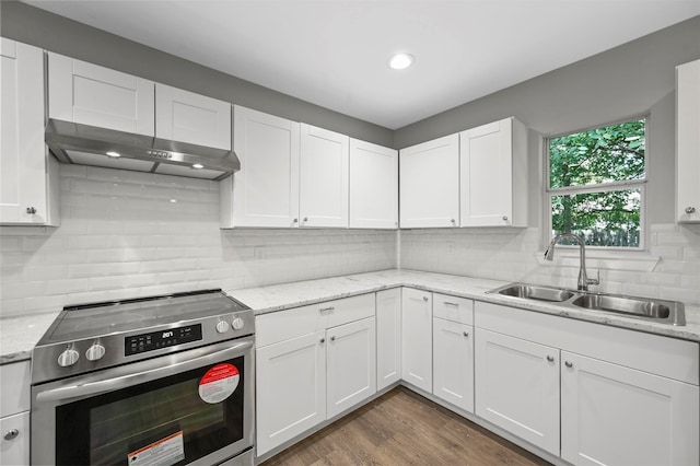 kitchen featuring electric stove, sink, white cabinetry, dark wood-type flooring, and light stone countertops