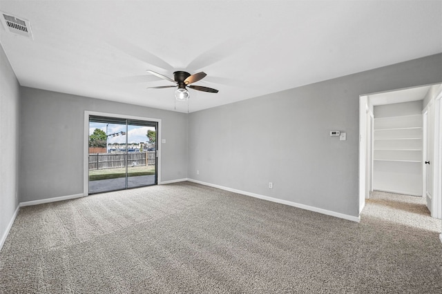 empty room featuring ceiling fan and carpet floors