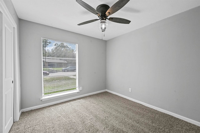 carpeted empty room featuring ceiling fan and a healthy amount of sunlight