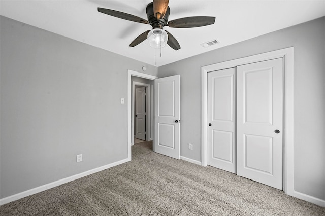 unfurnished bedroom with ceiling fan, a closet, and light carpet