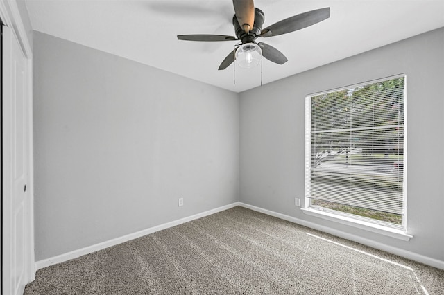 carpeted empty room with ceiling fan