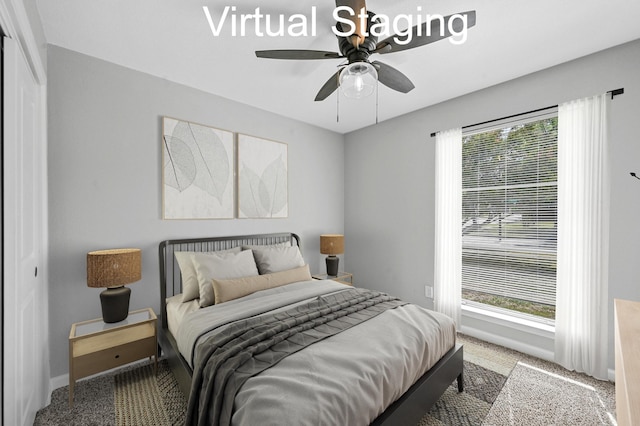 carpeted bedroom with ceiling fan and a closet