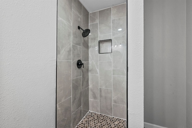 bathroom with tiled shower