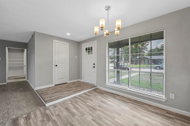 foyer featuring light hardwood / wood-style flooring and an inviting chandelier