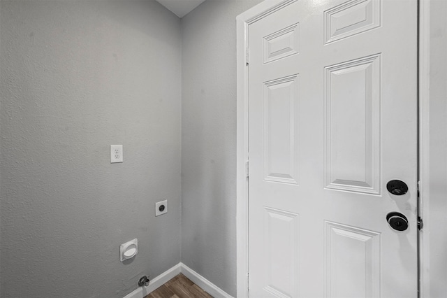 laundry room featuring wood-type flooring and hookup for an electric dryer