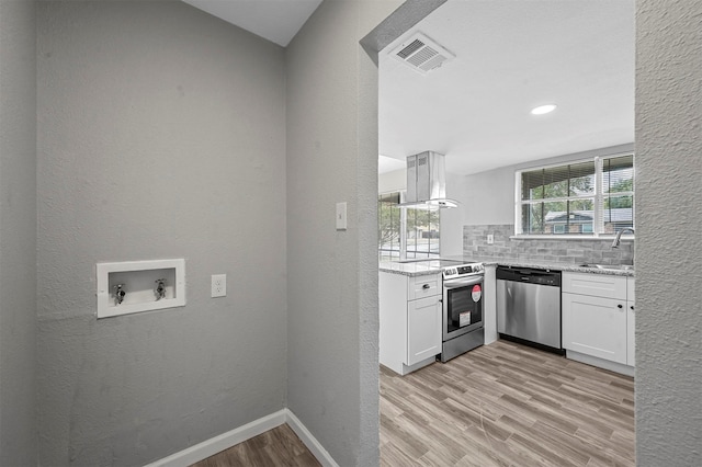 kitchen with white cabinets, stainless steel appliances, tasteful backsplash, and sink