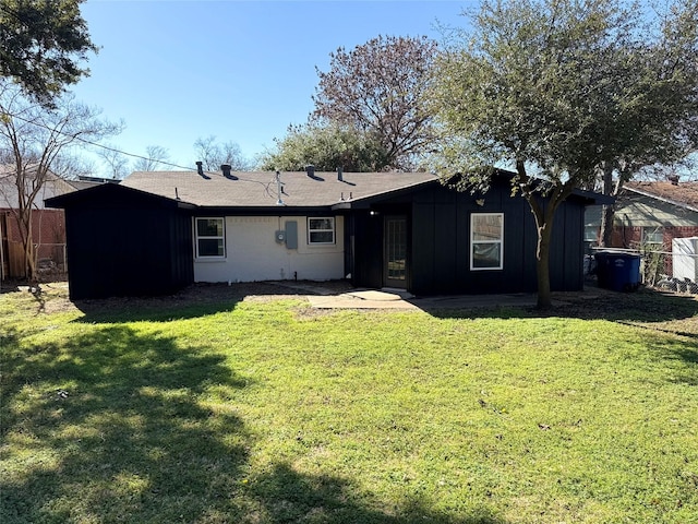 rear view of property featuring a yard