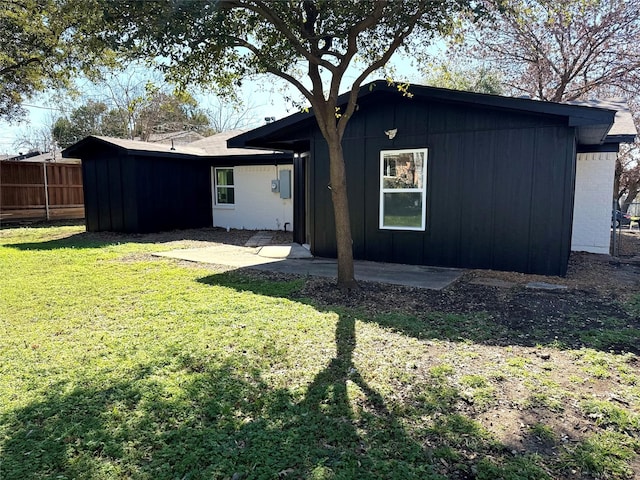 back of property featuring a lawn and a patio